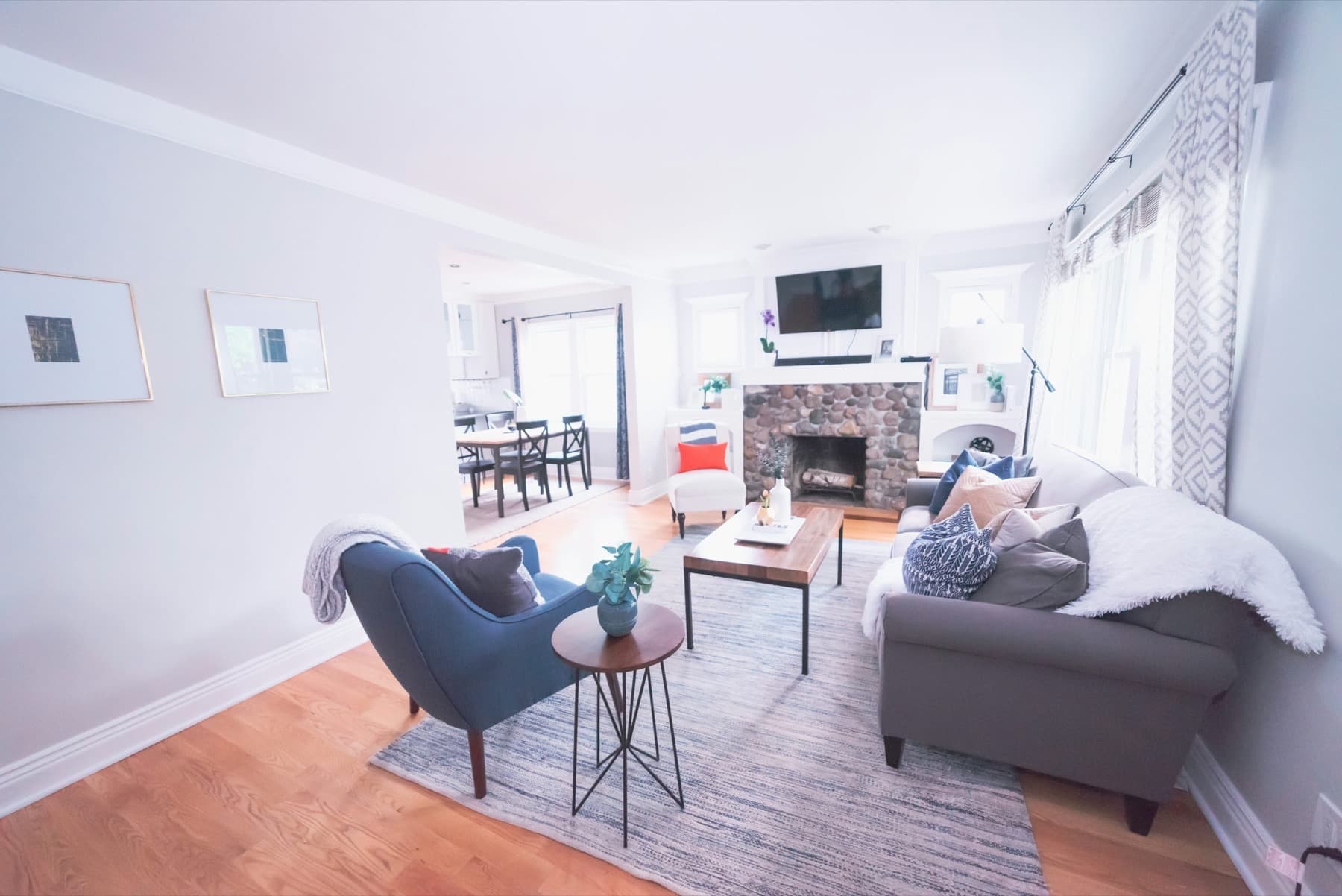 A bright condo living room with natural light and a seating area.