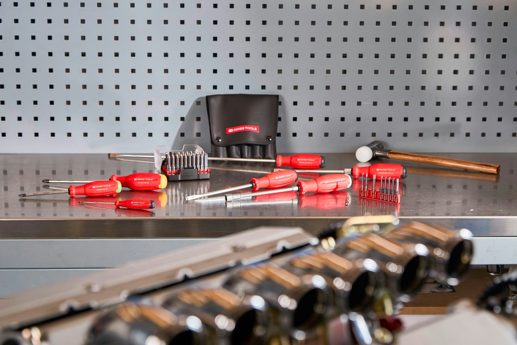 A set of repair tools on a workbench representing maintenance coordination.